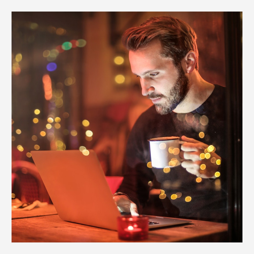 Man video chatting at a cafe